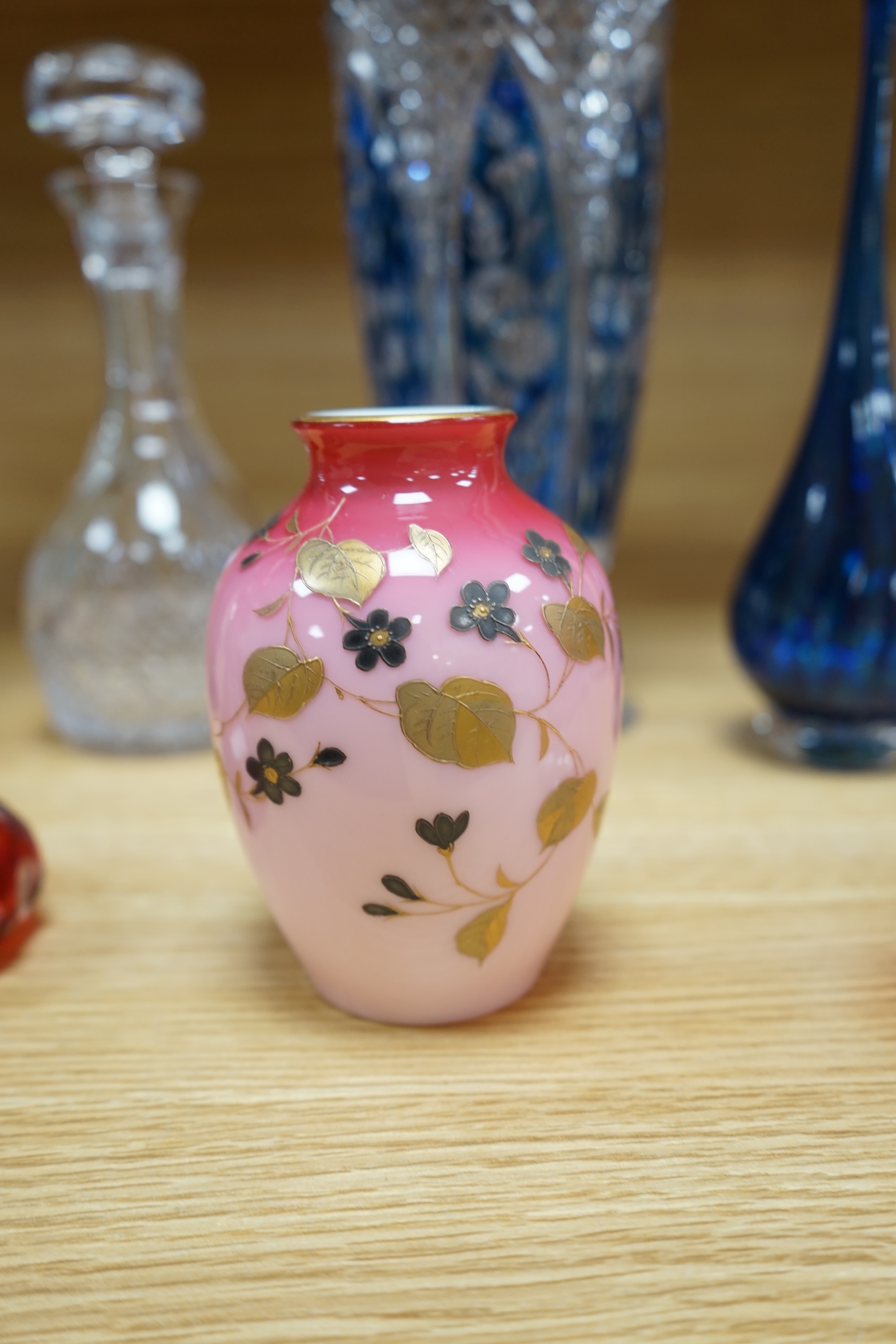 A collection of mixed 19th/20th century coloured glassware, to include a monogrammed cranberry bowl and plate, a flashed glass vase and a small opaque floral vase, largest 34cm high. Condition - fair to good